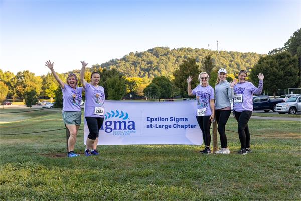 Race participants with sign